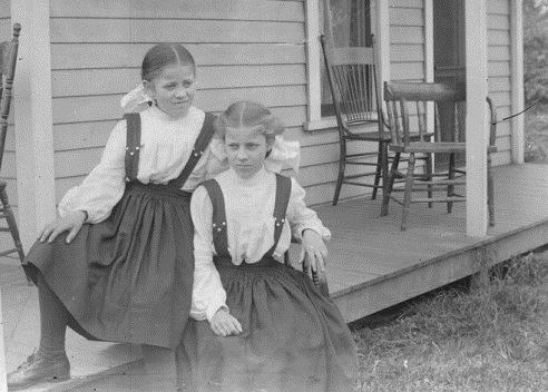 black and white photo of 2 young girls on a porch circa 1892